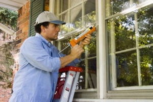 Man replacing windows on home